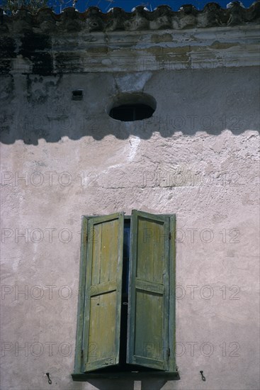 SPAIN, Balearic Islands, Menorca, Mahon.  Detail of house facade with green window shutter in Plaza Colon.