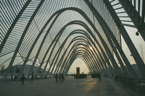 GREECE, Central, Athens, Olympic Stadium. People wandering through the walkway covered with arches in the evening.