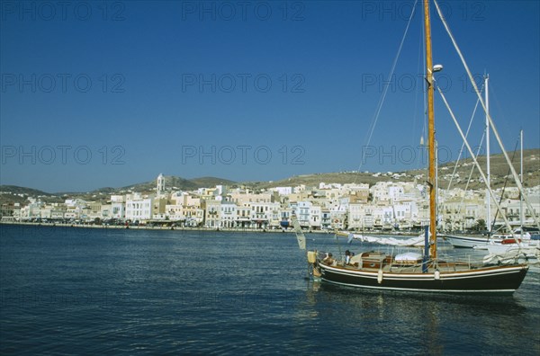 GREECE, Cyclades Islands, Syros, Ermoupolis. Sailing boats in the port with view of the seaside town.
