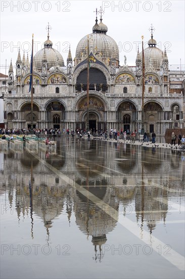 ITALY, Veneto, Venice, Aqua Alta High Water flooding in St Marks Square showing St Marks Basilica at the end of the flooded piazza