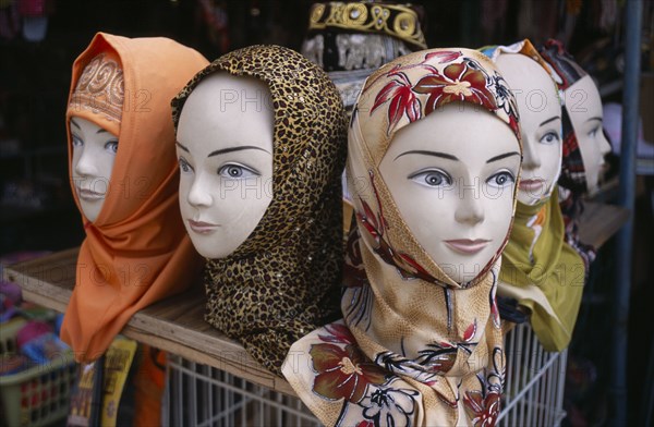 ISRAEL, Acre, Arabic mannequin heads displaying an array of different headscarves for sale on shop stall