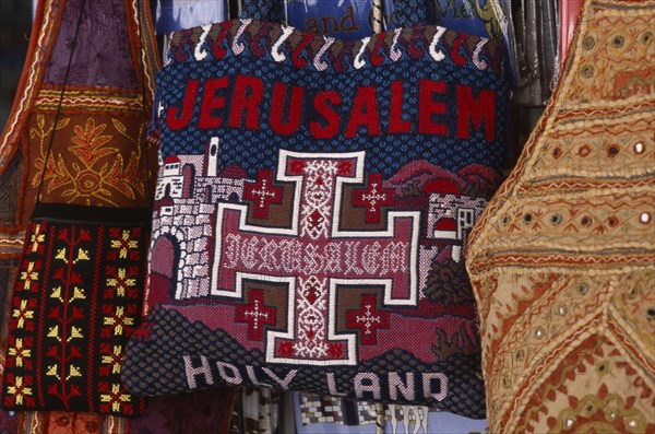 ISRAEL, Jerusalem, Old City. Detail of a handmade tourist bag decorated with the words Jerusalem Holy Land and an orthodox Christian Cross