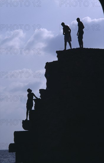 ISRAEL, Acre, Arab boys climbing the old harbour walls to jump into the sea