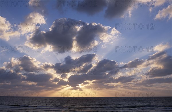 ISRAEL, Landscape, Sunset  with the sun behind a dramatic cloud formation over the Mediterranean Sea