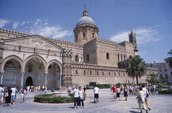ITALY, Sicily, Palermo, II Duomo Cathedral exterior with visitors walking around the complex towards the portico covered entrance