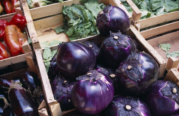 ITALY, Sicily, Palermo, La Vecciria Market. Fresh vegetables on market stall with detail of aubergines in wooden crates