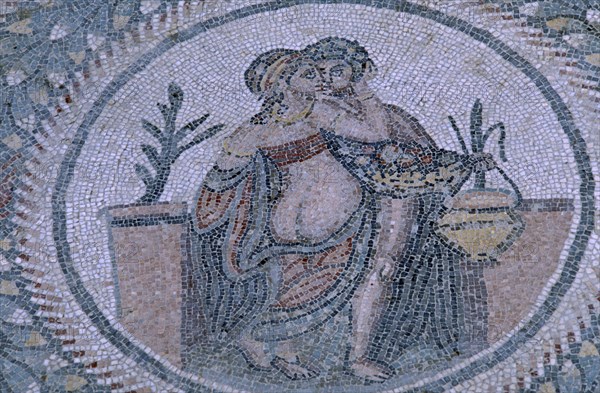 ITALY, Sicily, Enna, Piazza Armerina. Villa Romana del Casale. Detail of  a Roman Mosaic with a male and female figure encircled