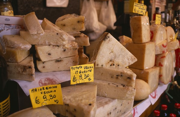 ITALY, Sicily, Catania, Market cheese stall with detail of a selection of cheeses and euro money price signs