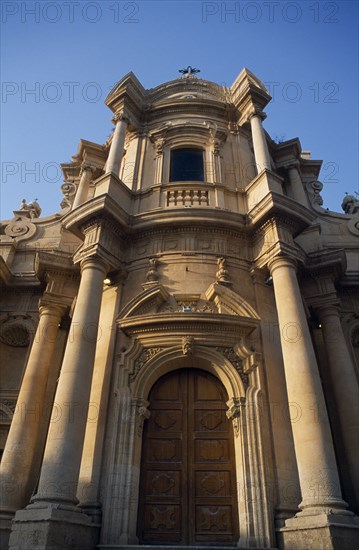 ITALY, Sicily, Noto, Church and Convent of San Domenico. Baroque golden sandstone facade with angled view of doorway