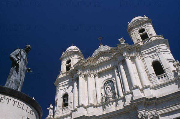 ITALY, Sicily, Catania, Via Etna. Collegiate church of Santa Maria del Elemosina with angled view of exterior and statue