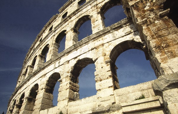 CROATIA, Istria, Pula, "Arches of Roman Arena. Built towards the end of the first century BC, the Arena is the sixth largest of its kind in the world and one of the best preserved. Once capable of seating 22,000 Roman spectators, it still retains its place as an entertainment venue, housing concerts throughout the summer months."
