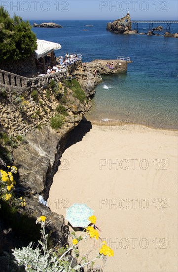 FRANCE, Aquitaine Pyrenees Atlantique, Biarritz, The Basque seaside resort on the Atlantic coast. The Plage de Port-Vieux with a seafood restaurant on a promontory at the end of the beach and the Rocher de la Vierge out to sea