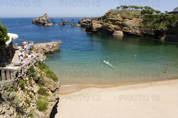 FRANCE, Aquitaine Pyrenees Atlantique, Biarritz, The Basque seaside resort on the Atlantic coast. The Plage de Port-Vieux with a seafood restaurant on a promontory at the end of the beach and the Rocher de la Vierge out to sea