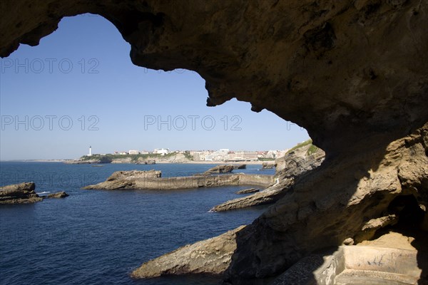 FRANCE, Aquitaine Pyrenees Atlantique, Biarritz, The Basque seaside resort on the Atlantic coast. The town and lighthouse seen through a rocky arch.