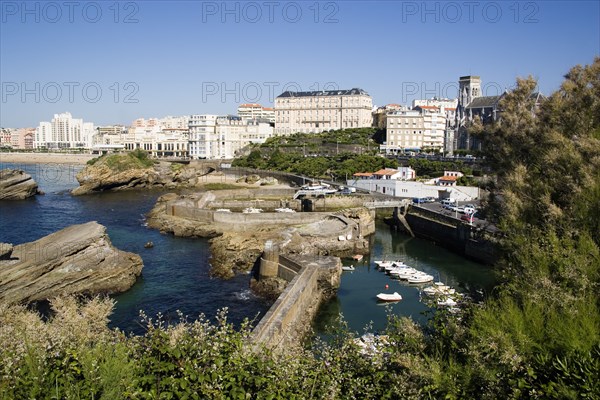 FRANCE, Aquitaine Pyrenees Atlantique, Biarritz, The Basque seaside resort on the Atlantic coast. Boats in the safe harbour of the Port des Pecheurs with the Grande Plage and town beyond