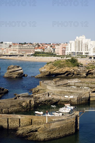 FRANCE, Aquitaine Pyrenees Atlantique, Biarritz, The Basque seaside resort on the Atlantic coast. Boats in the safe harbour of the Port des Pecheurs with the Grande Plage and town beyond