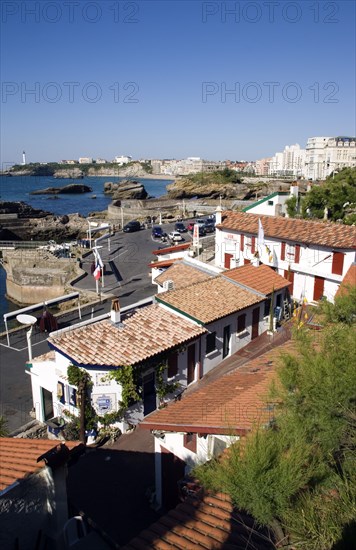 FRANCE, Aquitaine Pyrenees Atlantique, Biarritz, The Basque seaside resort on the Atlantic coast. Seafood restaurants in the Port des Pecheurs with the Grande Plage and town beyond