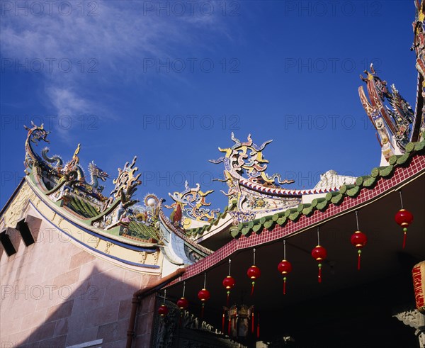 MALAYSIA, Penang, Georgetown, Chinese temple roof hung with red lanterns for Chinese New Year.