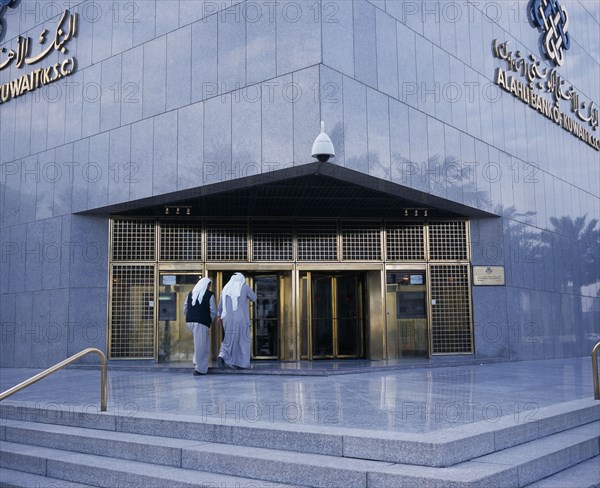 KUWAIT, Kuwait City, Exterior of Al-Ahli Bank of Kuwait with two men about to enter.