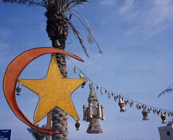 KUWAIT, Kuwait City, Gulf Road.  Crescent moon and lantern decorations for Eid at the end of Ramadan.