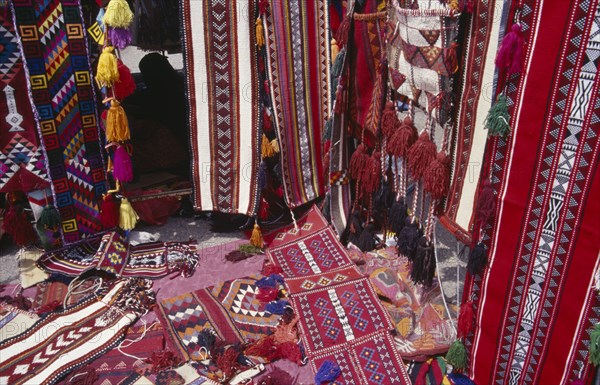 KUWAIT, Kuwait City, Brightly coloured Bedouin textiles for sale at Friday Market.
