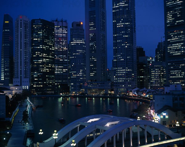 SINGAPORE, General, Singapore River basin and city skyline at night with lights from waterfront buildings reflected in water.