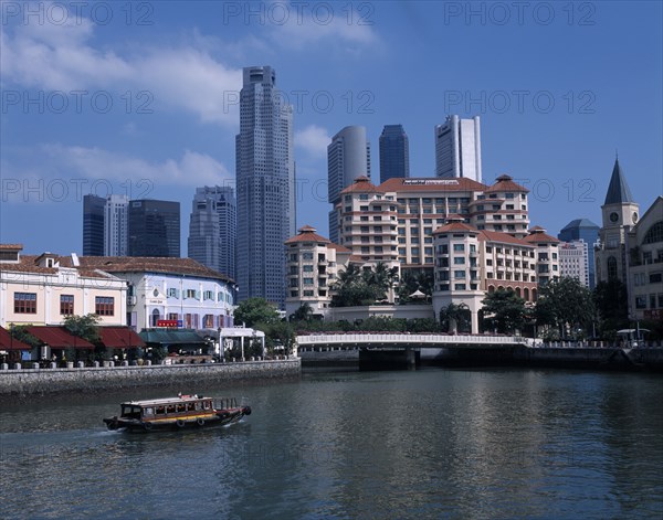 SINGAPORE, Clarke Quay, Boat on the Singapore River overlooked by hotel and high rise buildings.