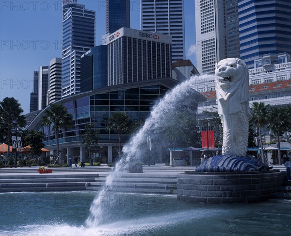 SINGAPORE, Merlion Park, Merlion statue and fountain in front of the Fullerton Hotel and city buildings including HSBC Bank and Tung Centre.