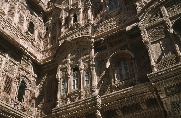 INDIA, Rajasthan, Jaisalmer, Patwon-ki-Haveli 1800-1860.  Sandstone house of wealthy merchant.  Part view of highly decorated exterior facade.