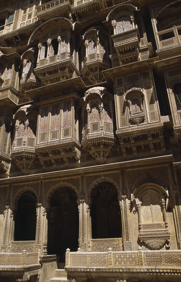 INDIA, Rajasthan, Jaisalmer, Patwon-ki-Haveli 1800-1860.  Sandstone house of wealthy merchant.  Part view of highly decorated exterior facade.