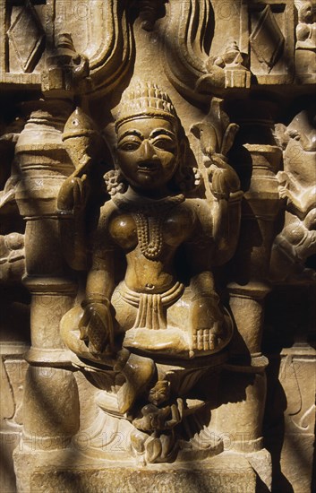 INDIA, Rajasthan, Jaisalmer, Carved Hindu iconography in Jain temple in Old City.  Close view disected by lines of shadow.