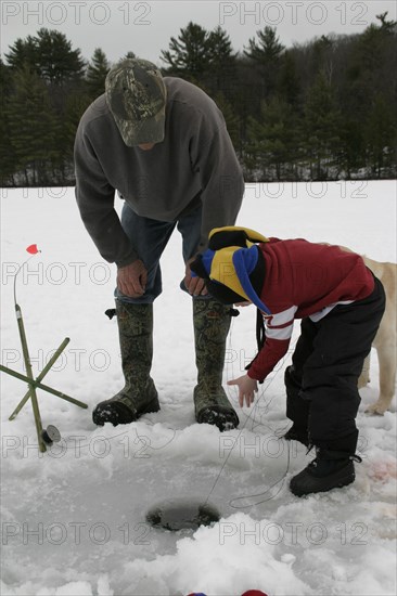 USA, New Hampshire, Marlborough , "Father and Son,Mike Stone and Tyler Stone ice fishing Meetinghouse Pond. "