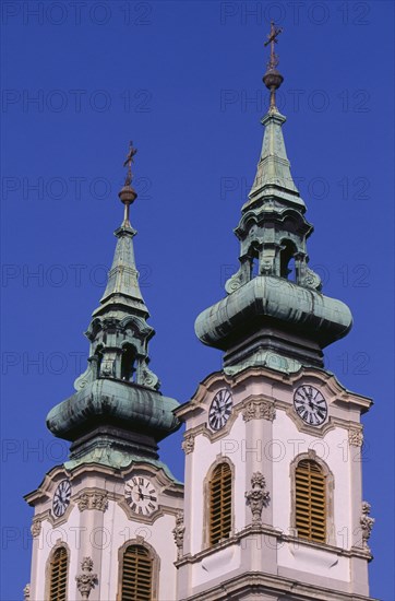HUNGARY, Budapest, Church of St Anne in Batthyany Square.  Detail of twin clock towers with copper spires.