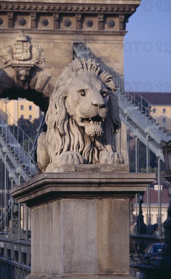 HUNGARY, Budapest, Stone statue of lion on Chain Bridge. Eastern Europe