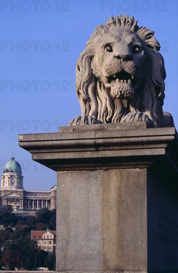 HUNGARY, Budapest, Stone statue of lion on Chain Bridge. Eastern Europe