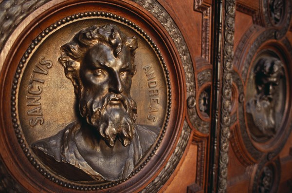 HUNGARY, Budapest, Basilica of St Stephen.  Detail of door with bronze relief carvings of the heads of the twelve apostles. Eastern Europe