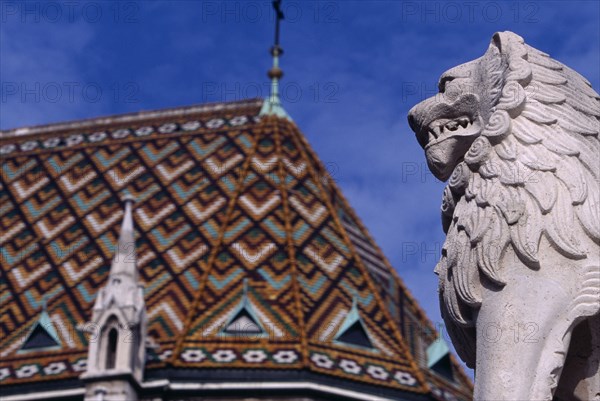 HUNGARY, Budapest, Castle Hill.  Matyas Church  part view of exterior roof and lion statue. Eastern Europe   Matthias Mathias