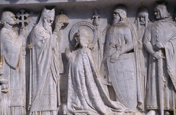 HUNGARY, Budapest, Detail of stone relief carving depicting a coronation on plinth of the equestrian statue of St Stephen in front of Matyas Church.  Eastern Europe