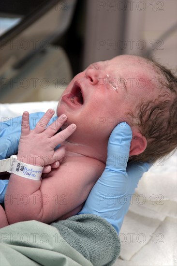 CHILDREN, Babies, Birth, "Kylan Stone, newborn baby girl crying, being checked by nurse in hospital."
