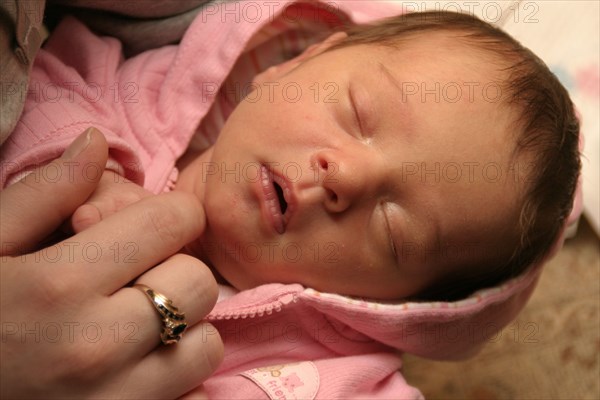 CHILDREN, Babies, Birth, "Kylan Stone, newborn baby girl holding mothers finger, 10 days old."