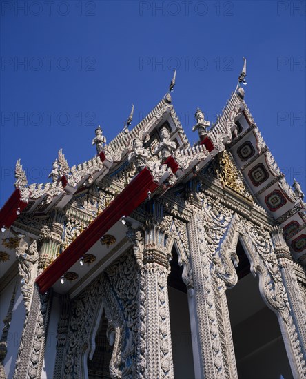 THAILAND, Bangkok, Sathorn District, Charoen Krung.  Highly decorated temple rooftop on Chao Phraya River