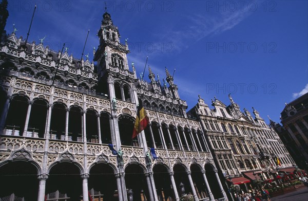 BELGIUM, Brabant, Brussels, Grand Place.  Maison du Roi exterior with Belgium flag flying from colonnaded facade.