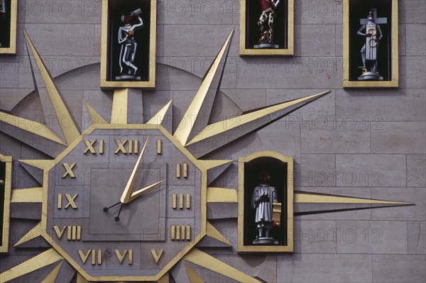 BELGIUM, Brabant, Brussels, Detail of building facade and Jacquemart clock.  Figures representing citizens of Brussels surround the clock face and move to announce the change of hour.