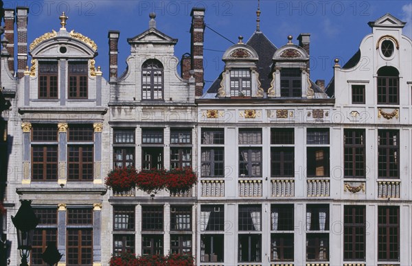 BELGIUM, Brabant, Brussels, Part view of building facades with gable rooftops and gilded decoration  balconies and flower filled window boxes.