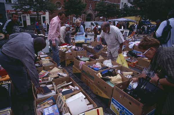 BELGIUM, Brabant, Brussels, "Flea Market. Place du Jeu de Balle, the Marolles. People rummaging through boxes at street market selling second hand goods and bric-a-brac.   "