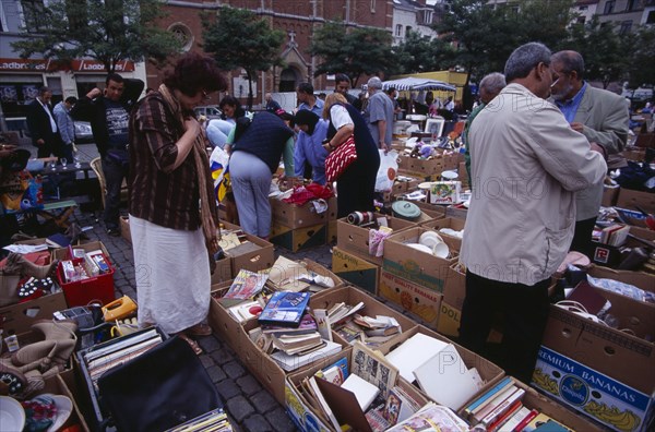 BELGIUM, Brabant, Brussels, "Flea Market. Place du Jeu de Balle, the Marolles. People rummaging through boxes at street market selling second hand goods and bric-a-brac.   "