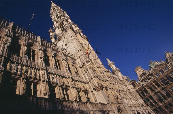 BELGIUM, Brabant, Brussels, The Grand Place.  Hotel de Ville.  Angled view of exterior facade decorated with statues representing the Dukes and Duchessess of Brabant.