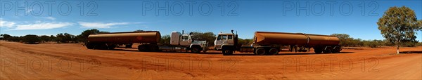 Australia, Western Australia, Outback, Panorama of rusting tankers on redut dust dirt road.