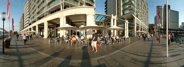 Australia, New South Wales, Sydney, Panorama Of Restaurants in Sydney Harbour At Sunset