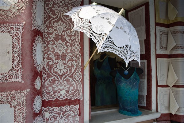 ITALY, Veneto, Venice, "Burano, one of the few inhabited islands in the lagoon famous for traditional lace production. Shop display of locally made lace"